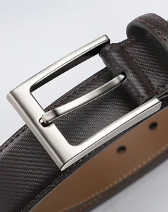 Detailed close-up of men's brown leather belt featuring metal pin buckle and textured pattern.
