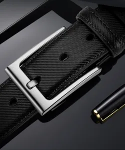 Men's leather belt detail close-up, textured strap with premium brushed metal pin buckle.