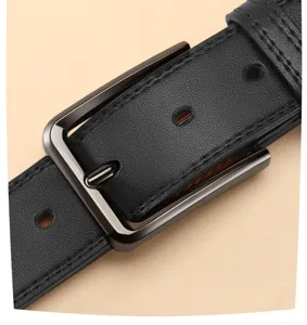 Close-up of black leather belt detail featuring a dark metal pin buckle and clear texture.