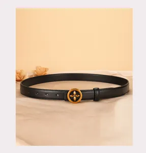 Close-up detail showing the elegant black leather strap and gold-toned vintage floral belt buckle.