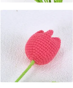 Handmade crochet pink tulip flower detail close-up, yarn floral craft decor texture