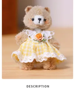 Close-up detail of a handmade fuzzy pipe cleaner bear doll wearing a cute yellow plaid dress.
