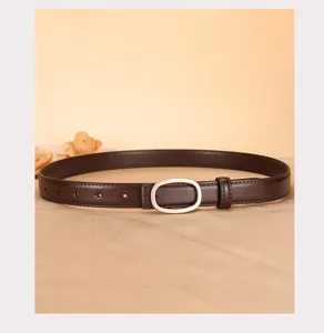 Classic brown leather belt for women with sleek silver oval buckle, detail shot.