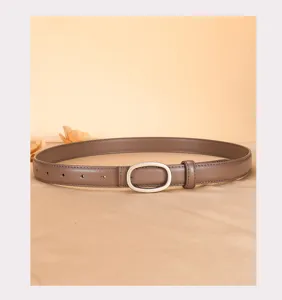 Detailed view of women's slim brown leather belt with elegant silver oval buckle, daily wear.
