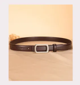 Detailed view of the dark brown leather belt with a simple silver rectangular buckle.