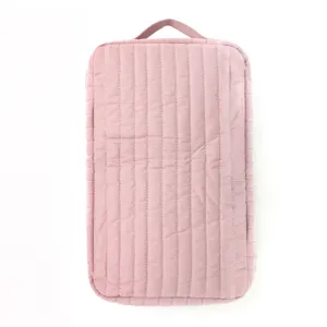 Pink quilted storage bag cosmetic pouch travel portable organizer with top handle.