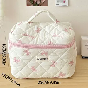 Quilted cosmetic bag with cute bow pattern, large capacity travel makeup storage organizer.