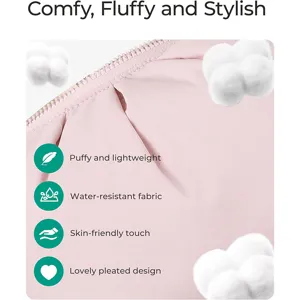 Close-up detail of a soft pink quilted cosmetic bag showcasing waterproof fabric and pleated design.