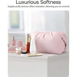 Soft pink cloud cosmetic bag detail shot, puffy PU leather travel pouch with spacious storage.