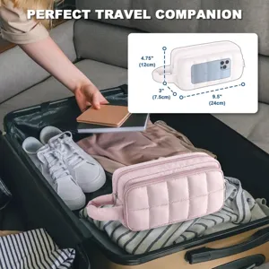 Pink quilted travel cosmetic bag with handle and clear phone pocket for easy packing.