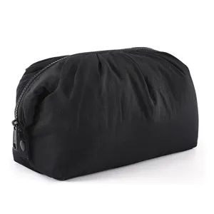 Close-up details of the black cloud cosmetic pouch, featuring soft gathered fabric and smooth zipper closure.