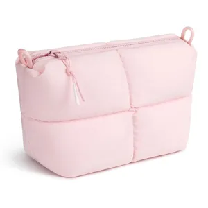 Pink quilted makeup bag detail, stylish casual cosmetic pouch with zipper closure and loops.