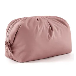 Close up of pink cloud cosmetic bag showing soft puffy fabric and smooth zipper detail.
