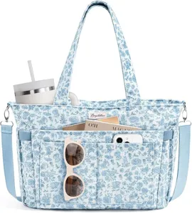 Detailed view of the blue floral corduroy tote bag featuring multiple front pockets and handles.