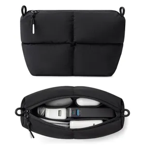Black quilted puffer cosmetic bag and travel tech organizer with large capacity zipper.