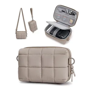 Padded quilted camera bag interior organization details with multiple mesh pockets and adjustable straps.