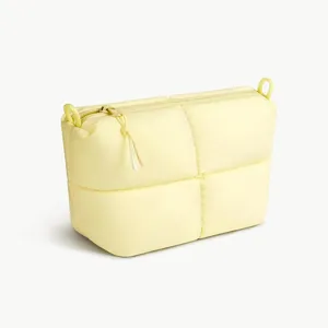 Minimalist yellow quilted cosmetic bag, casual puffer zip pouch with large storage capacity.