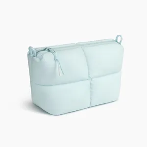 Light blue quilted puffy cosmetic bag, large capacity soft clutch for daily travel use.