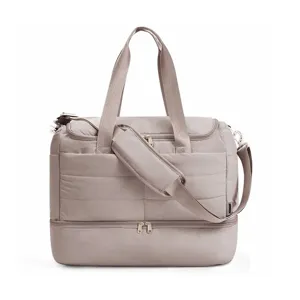 Quilted travel duffel bag for women, lightweight puffer weekender with separate bottom compartment.