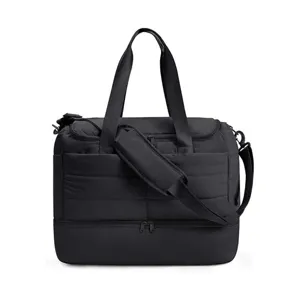 Black quilted travel duffel bag detail showing durable dual handles and separate bottom comp.