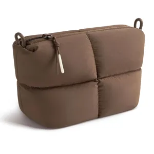 Brown quilted puffer cosmetic bag, stylish casual travel pouch for daily essentials.