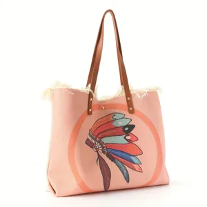 Stylish pink canvas tote bag featuring brown leather straps, fringe and ethnic print.