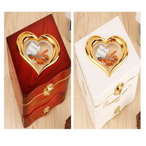 Wooden heart-shaped music jewelry box with violin and sheet music display inside, dual colors.