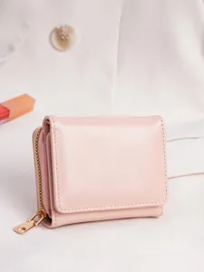 Detailed view of the cute pink trifold women wallet with zipper coin pocket and card slots.