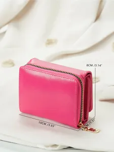 Detail shot of a vibrant pink compact tri-fold wallet with zipper coin pocket and specs.