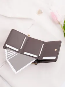 Dark brown trifold women wallet with multiple card slots and coin pocket detail shot.
