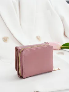 Compact pink women's trifold wallet with zipper coin pocket, stylish and practical for daily use.