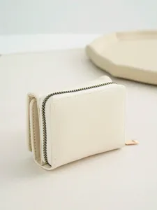 Minimalist beige trifold women's wallet with zipper coin pocket, compact design for daily use.