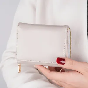 Compact women tri-fold wallet with zipper coin pocket, elegant minimalist design for daily use.