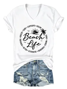 Detailed view of white V-neck short sleeve tee with beach life graphic and denim shorts.