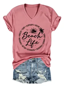 Detail view of the stylish pink V-neck t-shirt featuring beach life graphic print and short sleeves.