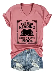 Detailed view of the pink V-neck short sleeve t-shirt with retro book reading chest print.