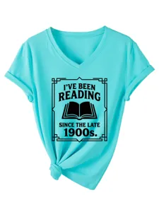 Turquoise V-neck t-shirt detail showing chest book graphic print and trendy knot hem style.