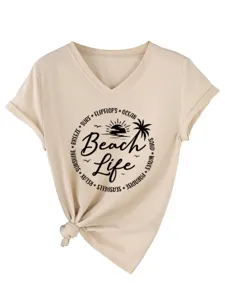 Close up detail of women casual V-neck t-shirt featuring beach life print and knot hem.