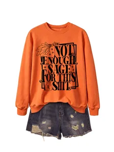 Women's orange long sleeve crewneck sweatshirt paired with denim shorts, casual autumn style.