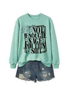 Close-up detail of the printed graphic quote on the mint green sweatshirt.