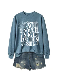 Casual blue long sleeve sweatshirt featuring graphic print paired with distressed denim shorts.
