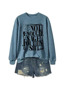 Casual long sleeve crewneck sweatshirt paired with distressed denim shorts for women.