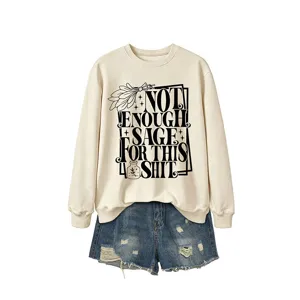 Women's long sleeve crewneck sweatshirt with funny sage quote graphic paired with denim shorts.