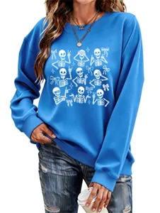 Close-up detail of women blue sweatshirt featuring cute white skeleton and bow graphic print.