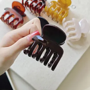 Detailed view of elegant brown hair claw clip, sturdy grip design for daily styling.