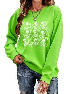 Close-up detail of women's green sweatshirt featuring fun skeleton and cute bow graphic prints.