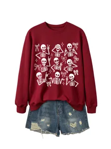 Close-up detail of the cute skeleton graphic and bow print on the maroon crewneck sweatshirt.
