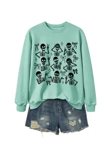 Women's mint green crewneck sweatshirt featuring stylish skeleton print paired with denim shorts.