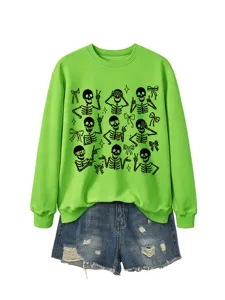 Detailed view of the bright green Halloween skeleton graphic sweatshirt paired with blue denim shorts.
