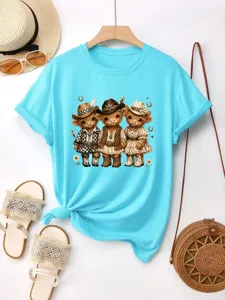Vista dettagliata della t-shirt in cotone blu da donna con stampa grafica di mucca western.